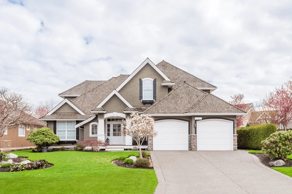 A front view of a two-story transitional home with a two-car garage. 