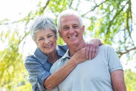 A smiling elderly couple. 