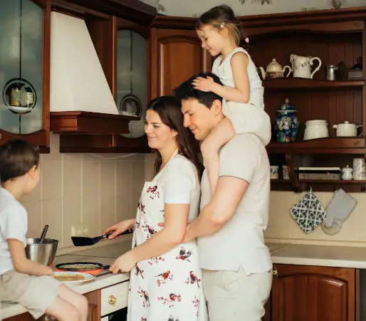 A family cooking together in the kitchen.