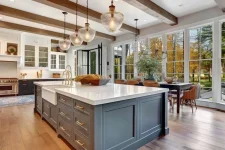 A picture of an elegant kitchen with a large island and a drop sink.