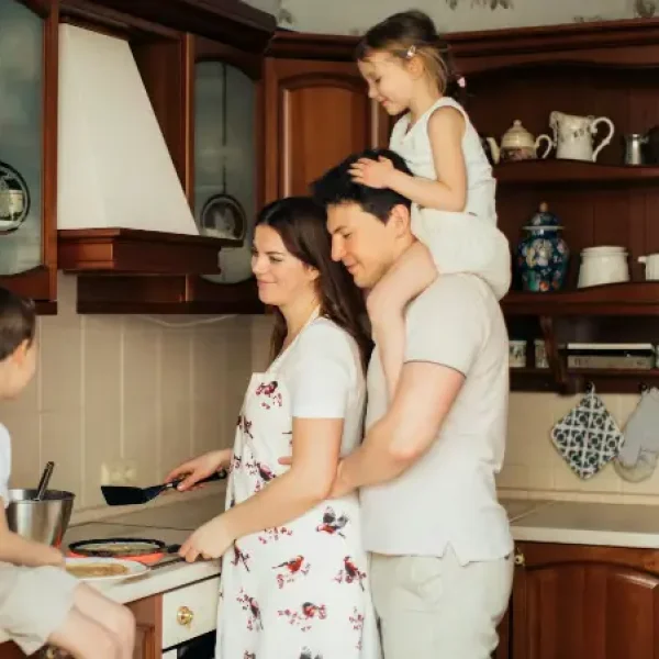 A family cooking together in the kitchen.